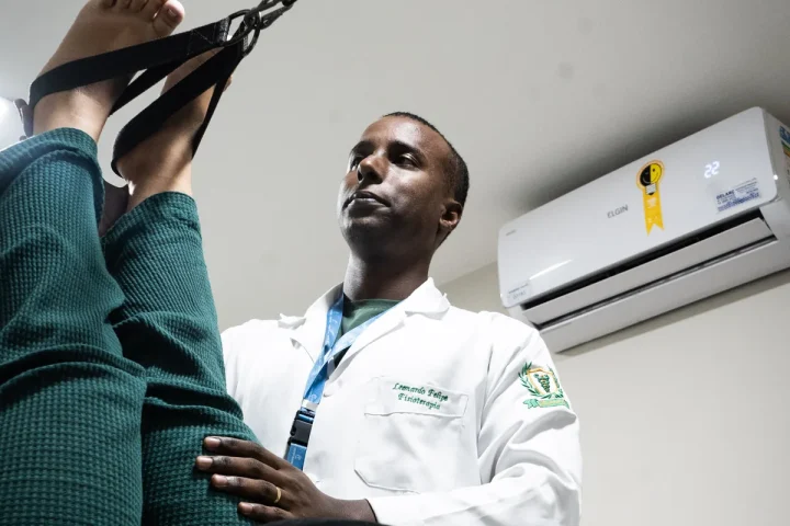 Fisioterapeuta da Center Trauma conduz alongamento ativo de cadeia posterior em sessão de RPG